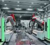 Zwei Roboterarme in einer Maschinenhalle. Fill entwickelt und produziert automatisierte Lösungen für die zerstörungsfreie Werkstoffprüfung mit hochgenauen Accubot-Robotern.